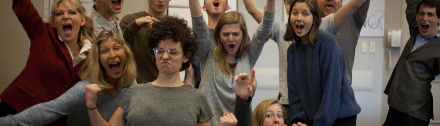 A group of people standing up in front of each other.